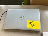 dell laptop with a yellow sticker on it sitting on a table