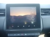 a picture of a car dashboard with the sun setting in the background