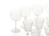 a lot of empty wine glasses on a white surface