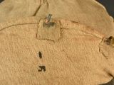 a close up of a military hat with a tag on it