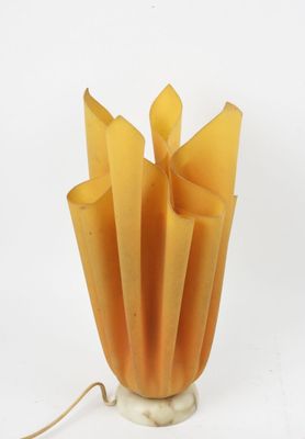 a yellow lamp that is sitting on a white table