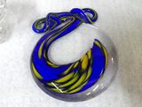 a blue and yellow swirl on a glass object on a table