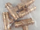 a bag of brass fittings on a white surface