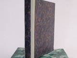two books sitting on top of each other on a white surface
