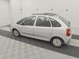 a picture of a small white car parked in a garage