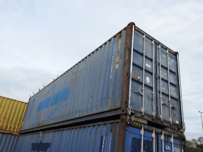 a large blue container sitting on top of a truck