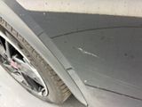 a close up of a car ' s front bumper with scratches on it