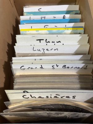 a lot of books in a box with writing on them