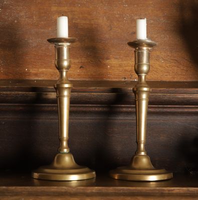 three candles that are sitting on a shelf