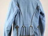 an old blue jacket hanging on a hanger on a wall