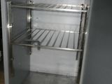 an empty refrigerator with a door open on a tiled floor
