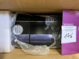a box with a microwave inside of it that is wrapped in plastic