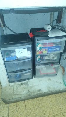 two plastic drawers that are under a sink in a bathroom