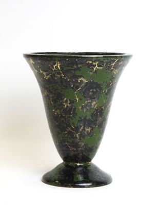 a black and green vase sitting on a white surface