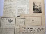 many old documents on a table with a picture of a castle