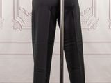 an image of a mannequin wearing a black suit and tie