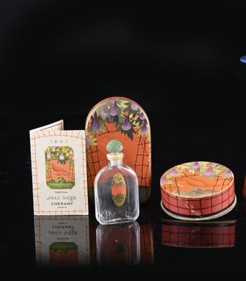 a small bottle of perfume next to a small box of soap
