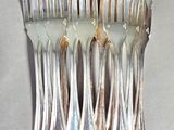 a lot of forks and spoons that are on the table