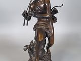 statue en bronze représentant un garçon avec une flûte et un chien