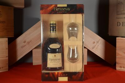 a bottle of liquor and a glass in a box