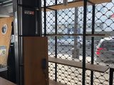 a picture of a room with a lot of shelves in it