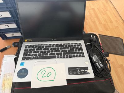 a laptop computer sitting on top of a black bag
