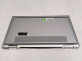 a silver laptop with a green sticker on it