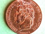 a close up of a penny on a table with a green background