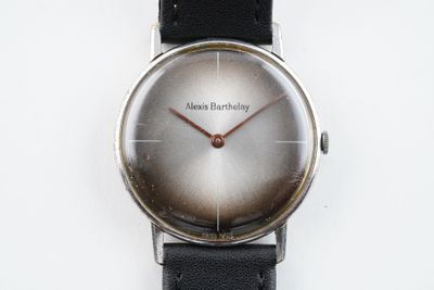 une image d'un gros plan d'une montre-bracelet sur une surface blanche