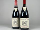 two bottles of red wine sitting next to each other on a table
