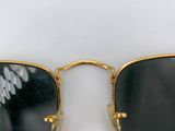 two pairs of sunglasses with writing on them sitting on a white surface