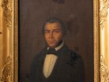 portrait of a man in a tuxedo in a gold frame