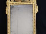 an image of a gold mirror with a bird on top of it