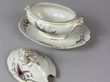 a small cup and saucer with a saucer on a saucer