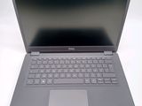 a dell laptop computer sitting on a white surface