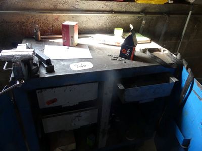 a workbench that has a lot of work on it