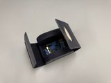 a black box with a pair of scissors inside of it