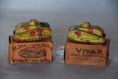 deux petits chars de jouet posés dans une boîte sur une table