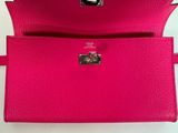 a pink purse with a metal clasp on it