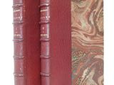 the two books are sitting side by side on a white surface