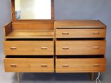 a wooden dresser with a mirror on top of it