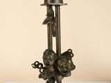 an old bronze statue of a man on a pole with a bird on it