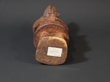 a small wooden statue of a man with a hat on his head