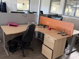 two desks and a chair in an office