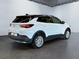 the rear end of a white car in a white room
