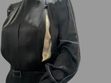 a mannequin wearing a black dress with gold detailing