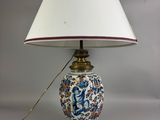 a lamp that is sitting on a table next to a lamp shade