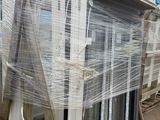 a lot of windows that are wrapped up on a pallet