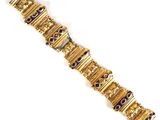 a close up of a gold bracelet with purple stones on it