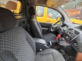 the interior of a car with a yellow truck in the background